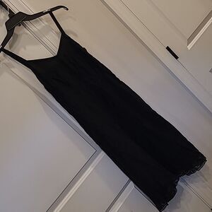Black sheath/slip has a side zipper, edged with soft lace. Vintage
